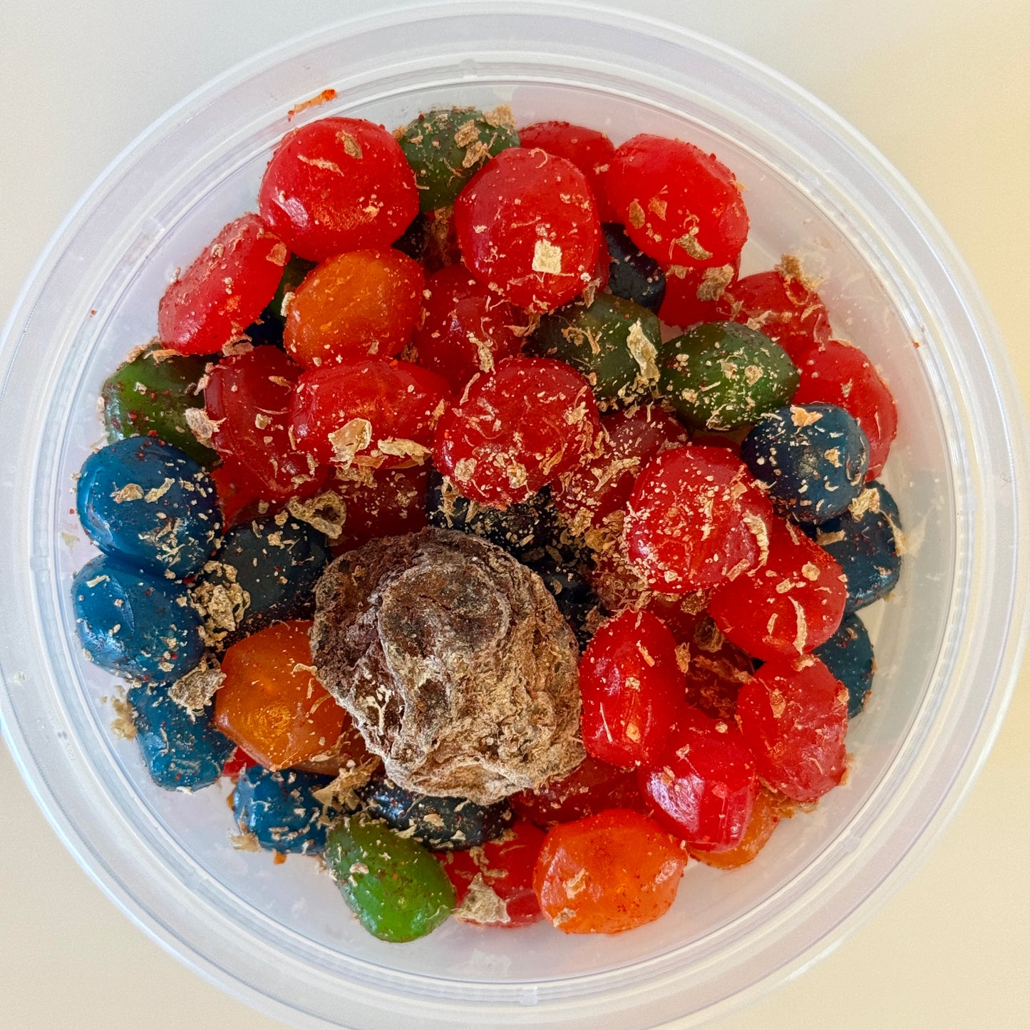 Aunty Kendra's Juicy Bursts: Fruit snacks with a liquid center, coated in signature Li Hing Mui powder and lemon peel.