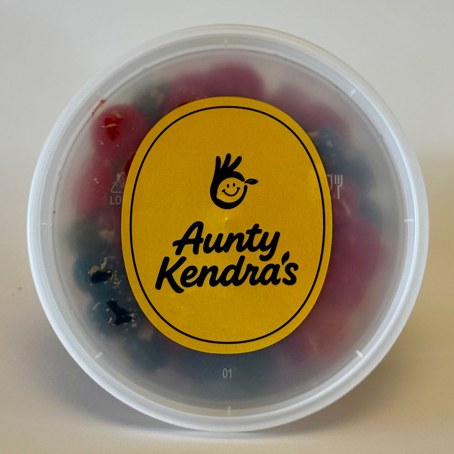 Aunty Kendra's Juicy Bursts: Fruit snacks with a liquid center, coated in signature Li Hing Mui powder and lemon peel.
