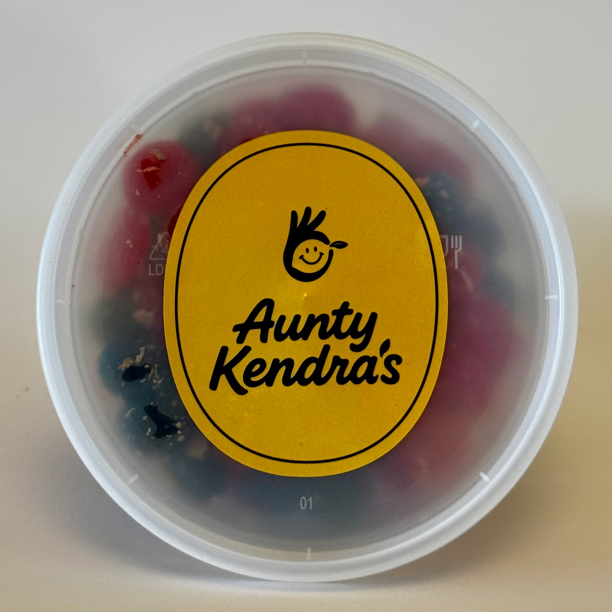 Aunty Kendra's Juicy Bursts: Fruit snacks with a liquid center, coated in signature Li Hing Mui powder and lemon peel.