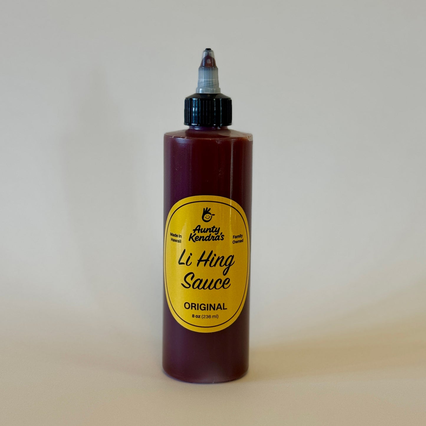Bottle of Aunty Kendra's Li Hing Sauce on a plain background