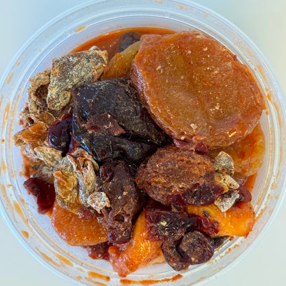Aunty Kendra's Prune Mui: A classic Hawaiian crackseed mix of wet dried plums and apricots marinated in savory Li Hing Mui sauce and lemon peel.