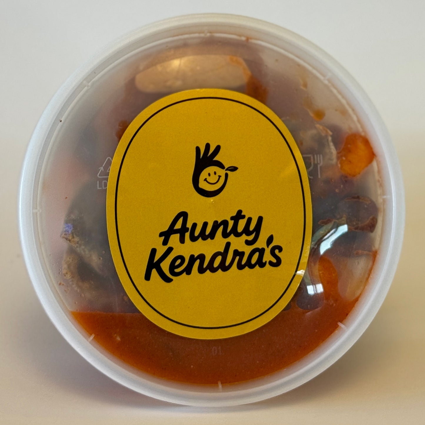 Aunty Kendra's Prune Mui: A classic Hawaiian crackseed mix of wet dried plums and apricots marinated in savory Li Hing Mui sauce and lemon peel.