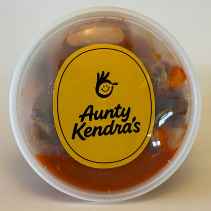 Aunty Kendra's Prune Mui: A classic Hawaiian crackseed mix of wet dried plums and apricots marinated in savory Li Hing Mui sauce and lemon peel.