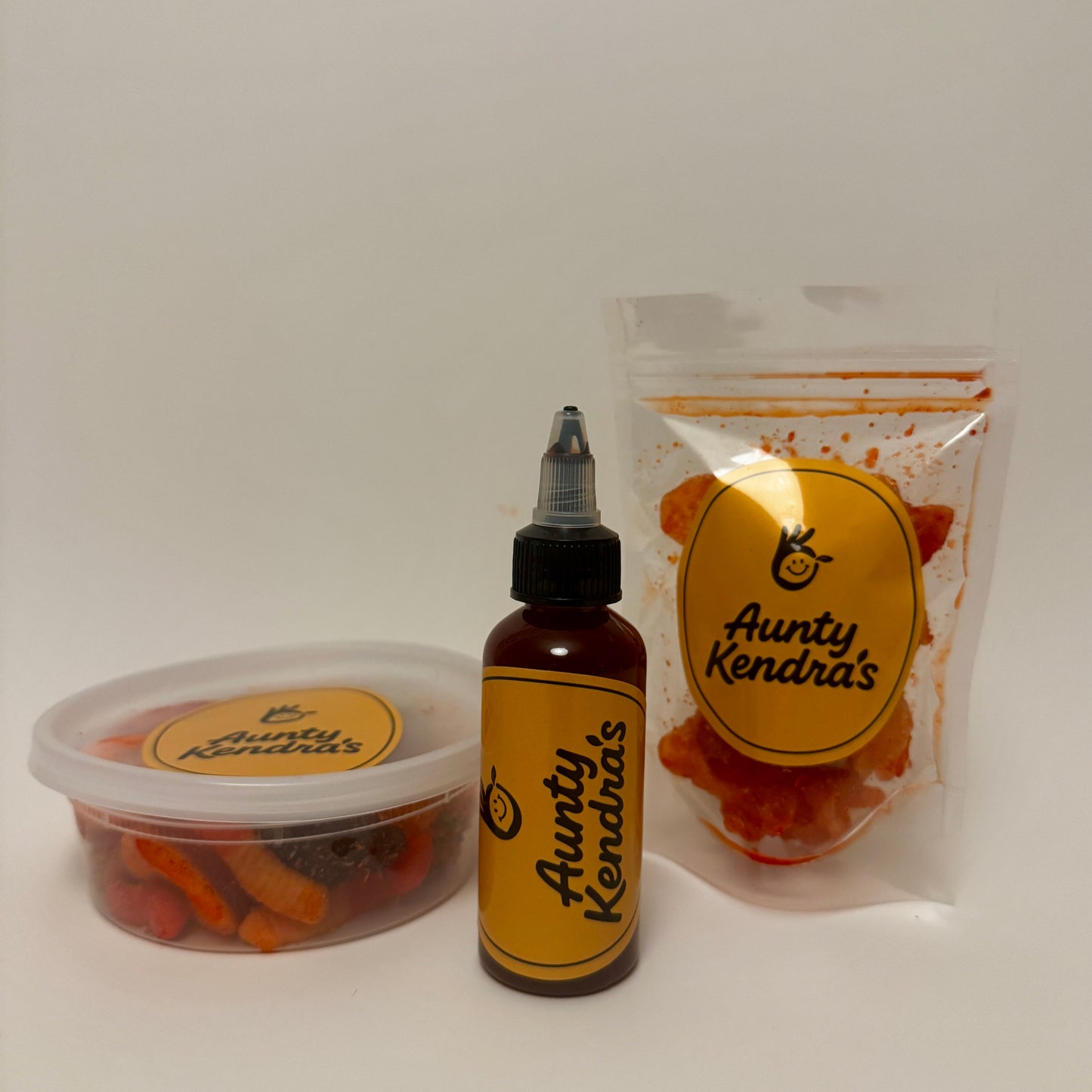 Aunty Kendra's Pau Hana Pack: A gift bundle featuring 8oz Li Hing Mui Sauce, a container of li hing gummies, and a dried fruit pouch.