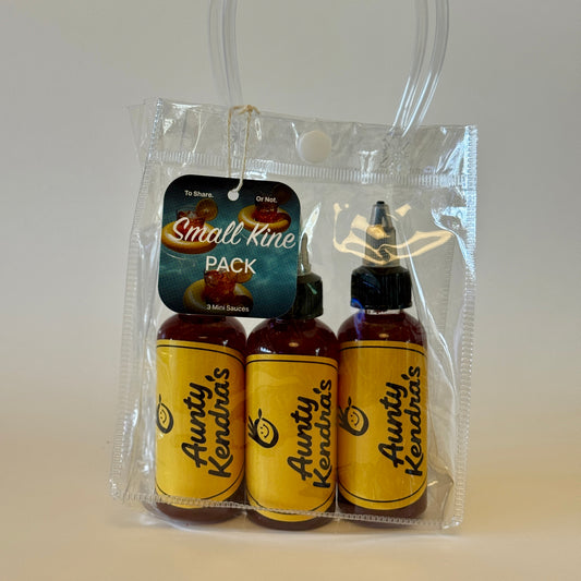 Three bottles of Aunty Kendra's sauce in a clear plastic pack on a white background
